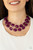 Two rows of dainty silver beads and faceted Magenta Purple faux stone beads alternate along invisible wires below the collar, creating bold, colorful layers. Features an adjustable clasp closure.

Sold as one individual necklace. Includes one pair of matching earrings.