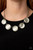 Featuring sleek silver fittings, a collection of round white cat's eye stone pendants link below the collar for a colorfully ethereal look. Features an adjustable clasp closure.

Sold as one individual necklace. Includes one pair of matching earrings.