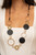 A shiny collection of mismatched silver rings and textured hoops link with round pieces of brown leather across the chest for a whimsically earthy look. The colorfully rustic compilation attaches to layered strands of shiny brown cording for a trendy finish. Features an adjustable clasp closure.
Sold as one individual necklace. Includes one pair of matching earrings. A shiny collection of mismatched silver rings and textured hoops link with round pieces of brown leather across the chest for a whimsically earthy look. The colorfully rustic compilation attaches to layered strands of shiny brown cording for a trendy finish. Features an adjustable clasp closure.
Sold as one individual necklace. Includes one pair of matching earrings.