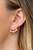 A solitaire white rhinestone attaches to a double-sided post, designed to fasten behind the ear. Radiating with a flared row of glassy white rhinestones, the double sided-post peeks out beneath the ear for an edgy look. Earring attaches to a standard post fitting.
Sold as one pair of post earrings. A solitaire white rhinestone attaches to a double-sided post, designed to fasten behind the ear. Radiating with a flared row of glassy white rhinestones, the double sided-post peeks out beneath the ear for an edgy look. Earring attaches to a standard post fitting.
Sold as one pair of post earrings.