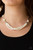Oversized white pearls and crystal-like beads give way to layers of beaded pearl strands below the collar for a timeless look. Features an adjustable clasp closure.

Sold as one individual necklace. Includes one pair of matching earrings.