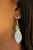 A lifelike silver leaf swings from a cluster of glittery green crystal-like beads, creating a spring inspired lure. Earring attaches to a standard fishhook fitting.

Sold as one pair of earrings.