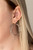 A warped piece of clear acrylic attaches to a double-sided post, while an oversized silver hoop peeks out beneath the ear for a bold look. Earring attaches to a standard post fitting.

Sold as one pair of double-sided post earrings.