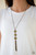 Sprinkled in glittery aurum prism style rhinestones, three sparkling brass frames trickle down the chest. A shimmery brass tassel swings from the bottom of the triple stacked pendant for a glamorous finish. Features an adjustable clasp closure.
Sold as one individual necklace. Includes one pair of matching earrings. Sprinkled in glittery aurum prism style rhinestones, three sparkling brass frames trickle down the chest. A shimmery brass tassel swings from the bottom of the triple stacked pendant for a glamorous finish. Features an adjustable clasp closure.
Sold as one individual necklace. Includes one pair of matching earrings.