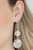 Oversized pink pearls and hammered silver discs delicately link into a bubbly lure for a refined flair. Earring attaches to a standard fishhook fitting.
Sold as one pair of earrings. Oversized pink pearls and hammered silver discs delicately link into a bubbly lure for a refined flair. Earring attaches to a standard fishhook fitting.
Sold as one pair of earrings.