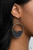 Featuring a triangular cut, a crescent shaped black wooden frame is fitted in place along the bottom of a shiny silver hoop, creating a retro lure. Earring attaches to a standard fishhook fitting.

Sold as one pair of earrings.