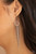Infused with a sparkly strand of glassy white rhinestones, tapered strands of dainty gunmetal ball chain stream from the bottom of a white rhinestone encrusted ring for a glamorously glittery look. Earring attaches to a standard fishhook fitting.
Sold as one pair of earrings. Infused with a sparkly strand of glassy white rhinestones, tapered strands of dainty gunmetal ball chain stream from the bottom of a white rhinestone encrusted ring for a glamorously glittery look. Earring attaches to a standard fishhook fitting.
Sold as one pair of earrings.