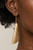 Delicately hammered in blinding shimmer, an asymmetrical gold frame delicately curls into an edgy statement piece. Earring attaches to a standard fishhook fitting.

Sold as one pair of earrings.
