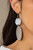 Embossed in tactile linear patterns, two mismatched silver discs link into a glistening lure. Earring attaches to a standard fishhook fitting.

Sold as one pair of earrings.