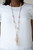 Dainty orange, blue, and pink wooden beads are sporadically threaded along earthy strands of knotted twine-like layers draped across the chest. Matching beaded strands stream out from the bottom of a decorative silver cap, creating a whimsical tassel. Features an adjustable clasp closure.
Sold as one individual necklace. Includes one pair of matching earrings. Dainty orange, blue, and pink wooden beads are sporadically threaded along earthy strands of knotted twine-like layers draped across the chest. Matching beaded strands stream out from the bottom of a decorative silver cap, creating a whimsical tassel. Features an adjustable clasp closure.
Sold as one individual necklace. Includes one pair of matching earrings.