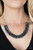 A sturdy silver chain connects double strands of Inkwell beads. The reflective multi-faceted beads connect below the collar for a fiercely stunning style. Features an adjustable clasp closure.
Sold as one individual necklace. Includes one pair of matching earrings. A sturdy silver chain connects double strands of Inkwell beads. The reflective multi-faceted beads connect below the collar for a fiercely stunning style. Features an adjustable clasp closure.
Sold as one individual necklace. Includes one pair of matching earrings.