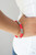 Stacks of rubbery red discs and bold silver rings are threaded along a stretchy band around the wrist, creating a versatile pop of color.

Sold as one individual bracelet.