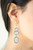 Gradually increasing in size, icy white oval gems trickle from the ear, linking into an ethereal lure. Earring attaches to a standard fishhook fitting.

Sold as one pair of earrings.