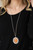 Bordered in bubbly white rhinestone encrusted petals, the center of a studded silver floral frame is dotted with an oversized orange cat's eye stone, creating a whimsical medallion at the bottom of a lengthened silver chain. Features an adjustable clasp closure.
Sold as one individual necklace. Includes one pair of matching earrings. Bordered in bubbly white rhinestone encrusted petals, the center of a studded silver floral frame is dotted with an oversized orange cat's eye stone, creating a whimsical medallion at the bottom of a lengthened silver chain. Features an adjustable clasp closure.
Sold as one individual necklace. Includes one pair of matching earrings.