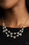 A bubbly collection of white pearls and glassy white rhinestones delicately connect into two timeless rows below the collar, creating a stunning statement piece. Features an adjustable clasp closure.
Sold as one individual necklace. Includes one pair of matching earrings. A bubbly collection of white pearls and glassy white rhinestones delicately connect into two timeless rows below the collar, creating a stunning statement piece. Features an adjustable clasp closure.
Sold as one individual necklace. Includes one pair of matching earrings.
