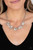 Clusters of glassy iridescent and shiny silver beads link with textured silver ovals, creating a bubbly effervescence below the collar. Features an adjustable clasp closure.

Sold as one individual necklace. Includes one pair of matching earrings.
