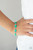 Encased in sleek silver frames, dewy Mint oval gems delicately connect around the wrist for an elegantly ethereal fashion. Features an adjustable clasp closure.
Sold as one individual bracelet. Encased in sleek silver frames, dewy Mint oval gems delicately connect around the wrist for an elegantly ethereal fashion. Features an adjustable clasp closure.
Sold as one individual bracelet.