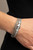 Infused with a silver beaded accent, rows of shiny Ultimate Gray cording join an Ultimate Gray leather band around the wrist. A hammered silver teardrop is knotted in place with Ultimate Gray thread, adding an artisanal touch to the colorfully rustic centerpiece. Features a magnetic closure.
Sold as one individual bracelet. Infused with a silver beaded accent, rows of shiny Ultimate Gray cording join an Ultimate Gray leather band around the wrist. A hammered silver teardrop is knotted in place with Ultimate Gray thread, adding an artisanal touch to the colorfully rustic centerpiece. Features a magnetic closure.
Sold as one individual bracelet.