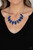 Generous bright blue glassy gems, dusted in shimmery gold, lay in silver oval frames and link across the collar creating a glimmering statement. Features an adjustable clasp closure.
Sold as one individual necklace. Includes one pair of matching earrings. Generous bright blue glassy gems, dusted in shimmery gold, lay in silver oval frames and link across the collar creating a glimmering statement. Features an adjustable clasp closure.
Sold as one individual necklace. Includes one pair of matching earrings.