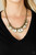 Featuring regal emerald cuts, white rhinestones gradually increase in size as they glide along a rounded brass snake chain below the collar. Separated by stacks of brass rings, the brilliant rhinestones are encased in matte brass frames for a glamorously gritty finish. Features an adjustable clasp closure.
Sold as one individual necklace. Includes one pair of matching earrings. Featuring regal emerald cuts, white rhinestones gradually increase in size as they glide along a rounded brass snake chain below the collar. Separated by stacks of brass rings, the brilliant rhinestones are encased in matte brass frames for a glamorously gritty finish. Features an adjustable clasp closure.
Sold as one individual necklace. Includes one pair of matching earrings.