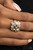 Encased in sleek gold frames, a bubbly collection of sparkly white rhinestones coalesces into a glamorous band across the finger. Features a stretchy band for a flexible fit.

Sold as one individual ring.