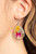 A colorful collection of wildflowers is encased inside a glassy teardrop casing bordered in silver, creating a whimsical display. Earring attaches to a standard fishhook fitting.

Sold as one pair of earrings.