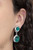 Encased in sleek silver fittings, two green cat's eye stones link into a whimsical lure. Earring attaches to a standard clip-on fitting.

Sold as one pair of clip-on earrings.