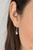 Dotted in glassy white rhinestones, leafy silver filigree blooms from an oversized brown cat's eye stone, creating an enchanted pendant at the bottom of a lengthened silver chain. Features an adjustable clasp closure.
Sold as one individual necklace. Includes one pair of matching earrings. Dotted in glassy white rhinestones, leafy silver filigree blooms from an oversized brown cat's eye stone, creating an enchanted pendant at the bottom of a lengthened silver chain. Features an adjustable clasp closure.
Sold as one individual necklace. Includes one pair of matching earrings.
