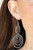 Dotted with dainty black rhinestones, hammered silver ovals join in concentric frames that link into a dizzying lure. Earring attaches to a standard fishhook fitting.

Sold as one pair of earrings.