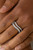 Varying in size, glittery white rhinestones are encrusted along waving silver bands for a refined look. Features a dainty stretchy band for a flexible fit.

Sold as one individual ring.