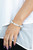 Infused with silver accents, a dreamy collection of glassy and opalescent white beads are threaded along a stretchy band around the wrist for an enchanting glow.
Sold as one individual bracelet. Infused with silver accents, a dreamy collection of glassy and opalescent white beads are threaded along a stretchy band around the wrist for an enchanting glow.
Sold as one individual bracelet.