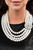 Inspired by royalty, an elegant explosion of classic white rhinestones and timeless pearls delicately coalesces into a vintage brooch. The refined ornament delicately holds together strands of oversized pearls, creating romantically regal layers below the collar. Features an adjustable clasp closure.
Sold as one individual necklace. Includes one pair of matching earrings. Inspired by royalty, an elegant explosion of classic white rhinestones and timeless pearls delicately coalesces into a vintage brooch. The refined ornament delicately holds together strands of oversized pearls, creating romantically regal layers below the collar. Features an adjustable clasp closure.
Sold as one individual necklace. Includes one pair of matching earrings.
