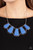 Encased in hammered silver fittings, trapezoidal blue acrylic frames delicately fan out below the collar for a dramatic pop of color. Features an adjustable clasp closure.

Sold as one individual necklace. Includes one pair of matching earrings.