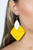 A leaf shaped white wooden frame delicately overlaps with an intricately woven Illuminating wicker-like frame, creating a sunny pop of color. Earring attaches to a standard fishhook fitting.

Sold as one pair of earrings.