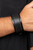 Shiny black cording boldly crisscrosses across the front of a thick black leather band, creating an edgy centerpiece around the wrist. Features a buckle closure.

Sold as one individual bracelet.