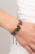 Featuring airy stenciled cutouts, three gunmetal butterflies delicately connect at the center of a gunmetal box chain for a whimsical fashion. Features an adjustable sliding bead closure.

Sold as one individual bracelet.