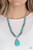 Faceted oval turquoise stones, studded silver accents, and floral stamped silver beads are threaded along an invisible wire that attaches to a classic silver chain. An oversized turquoise teardrop stone swings from the bottom of the beaded strand, creating an earthy pendant below the collar. Features an adjustable clasp closure.
Sold as one individual necklace. Includes one pair of matching earrings. Faceted oval turquoise stones, studded silver accents, and floral stamped silver beads are threaded along an invisible wire that attaches to a classic silver chain. An oversized turquoise teardrop stone swings from the bottom of the beaded strand, creating an earthy pendant below the collar. Features an adjustable clasp closure.
Sold as one individual necklace. Includes one pair of matching earrings.