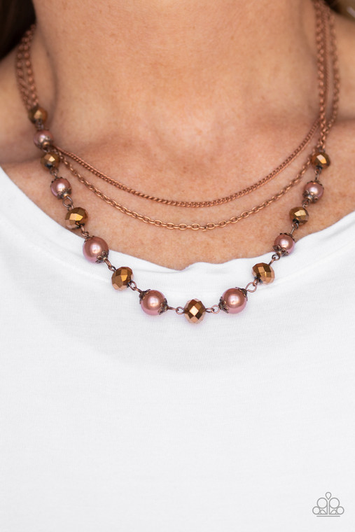 Infused with two layers of dainty copper chains, pearly copper beads and coppery aurum rhinestones link below the collar for a demure look. Features an adjustable clasp closure.