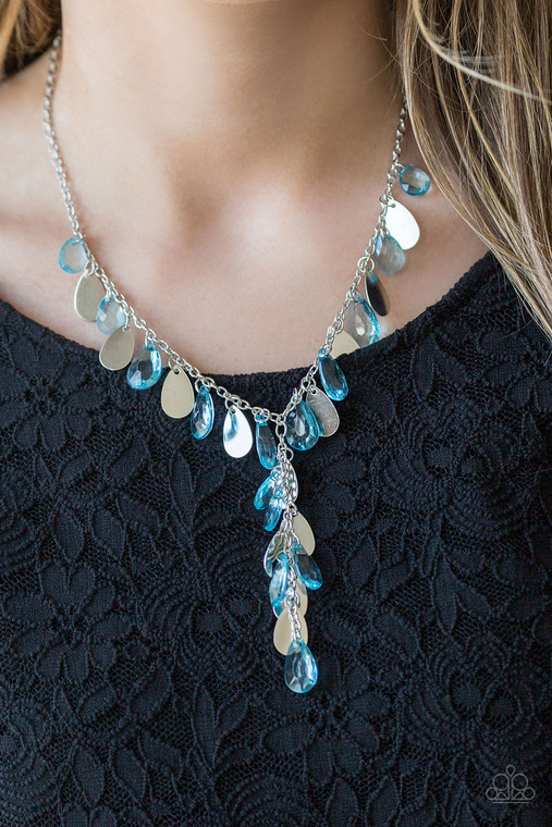 Flat silver teardrops and blue crystal-like teardrops swing from the bottom of a shimmery silver chain below the collar. A matching tassel swings from the center, creating a whimsical extended pendant. Features an adjustable clasp closure.

Sold as one individual necklace. Includes one pair of matching earrings.