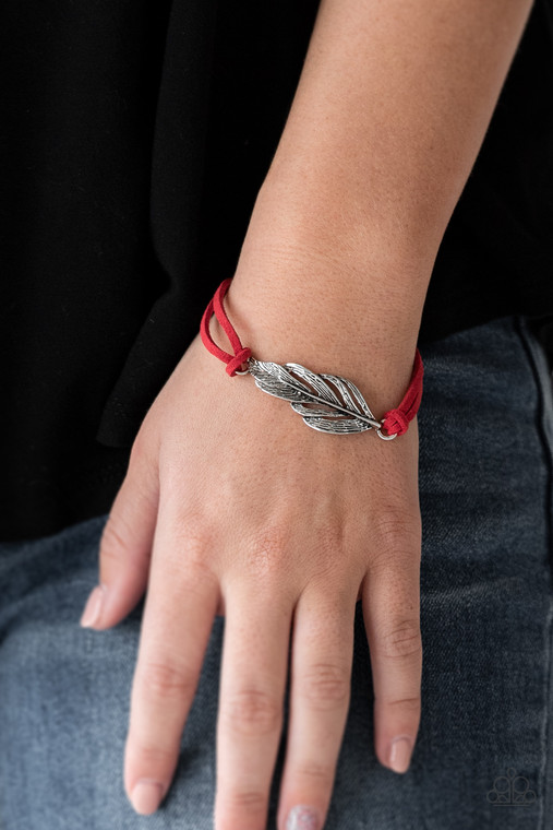 Strands of fiery red suede knot around a shimmery silver feather charm, creating a seasonal pendant atop the wrist. Features an adjustable clasp closure.

Sold as one individual bracelet.