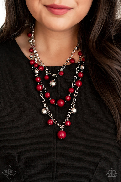 Three silver chains layer down the chest, creating a cascade of shimmer. Beads tinted in a deep red wine hue are mixed with timeless metallic accents that dance along the chains in a colorful statement-making finish. Features an adjustable clasp closure.

Sold as one individual necklace. Includes one pair of matching earrings.