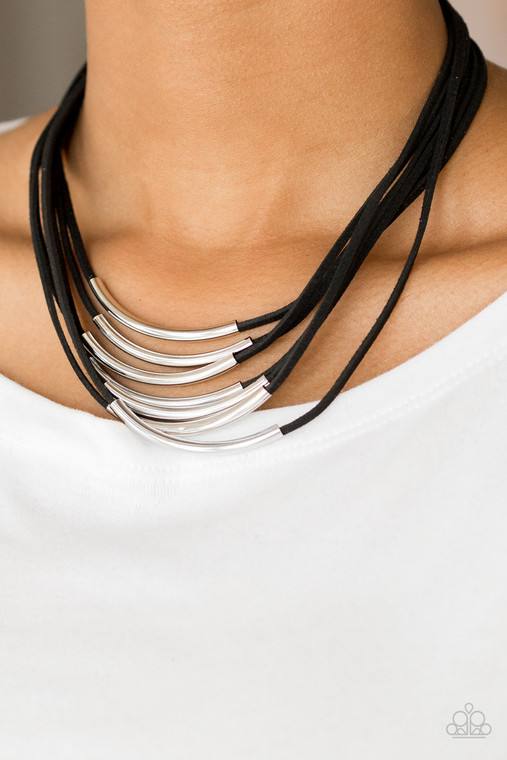 Glistening silver rods slide along strips of black suede, creating earthy layers below the collar. Features an adjustable clasp closure.

Sold as one individual necklace. Includes one pair of matching earrings.