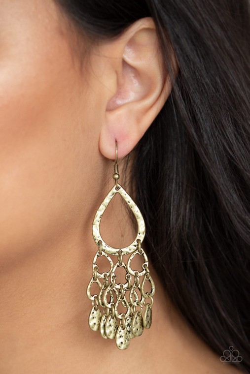 Hammered brass teardrop silhouettes and brass teardrop beads trickle from the bottom of a larger hammered teardrop, creating an edgy lure. Earring attaches to a standard fishhook fitting.

Sold as one pair of earrings.