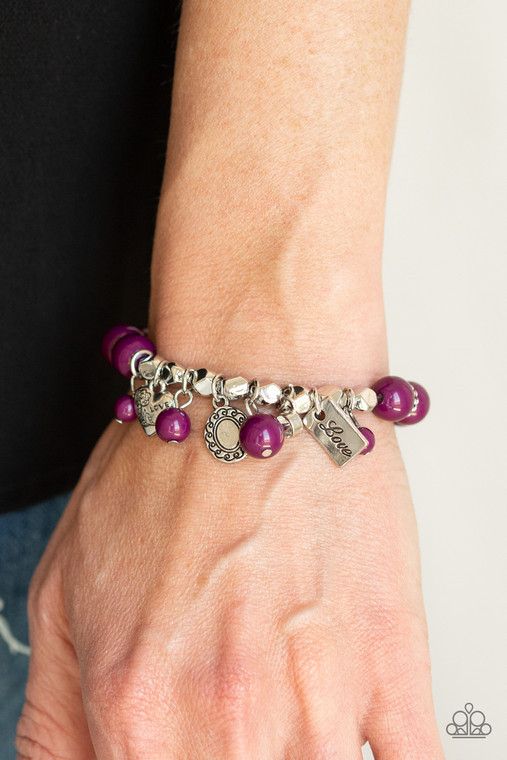 Stamped in floral details and the word, "Love," a romantic assortment of silver charms and a dainty white rhinestone swings from a plum beaded bracelet around the wrist for a charmingly colorful look.

Sold as one individual bracelet.
