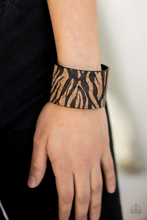 Featuring a black zebra pattern, an earthy cork-like cuff curls around the wrist for a wild look.

Sold as one individual bracelet.