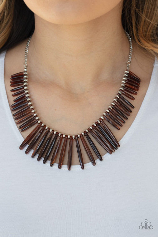 Flanked by dainty silver beads, smoky brown rod-like acrylic frames are threaded along an invisible wire, creating a colorful fringe below the collar. Features an adjustable clasp closure.

Sold as one individual necklace. Includes one pair of matching earrings.