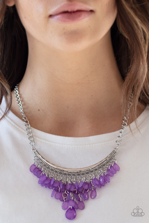 Varying in size, opaque purple teardrops drip from the bottom of a bowing silver bar, creating an effervescent fringe below the collar. Features an adjustable clasp closure.

Sold as one individual necklace. Includes one pair of matching earrings.