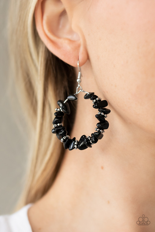 Bits of black rock and studded silver rings are threaded along a dainty wire, creating an earthy hoop. Earring attaches to a standard fishhook fitting.

Sold as one pair of earrings.