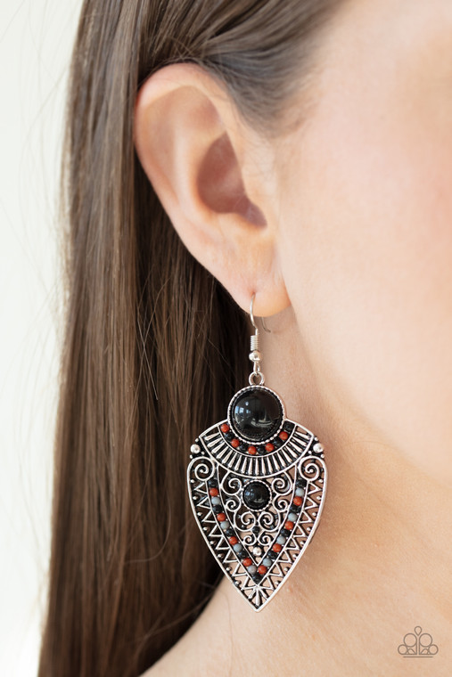 Black, Cinnamon Stick, and Ash beads decorate the front of a spade shaped silver frame radiating with linear and zigzagging details for a tribal inspired look. Earring attaches to a standard fishhook fitting.

Sold as one pair of earrings.
