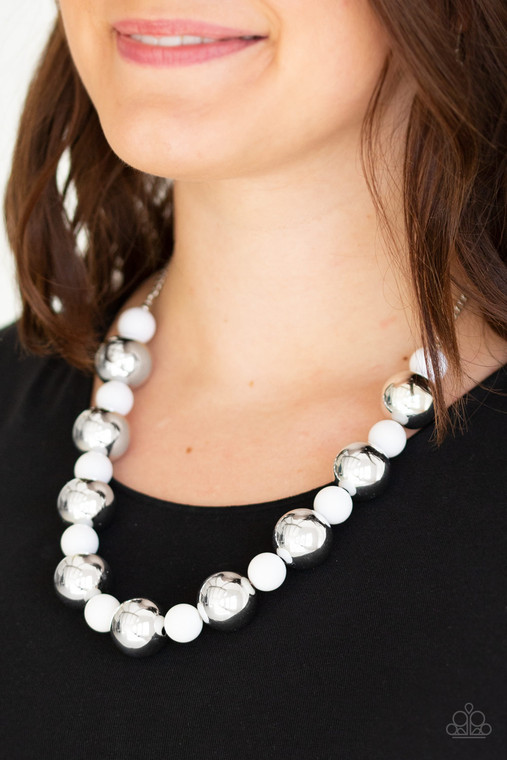 Polished white beads and dramatic silver beads drape below the collar for a perfect pop of color. Features an adjustable clasp closure.

Sold as one individual necklace. Includes one pair of matching earrings.